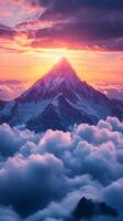 Mountain with clouds and sun rising over it photo