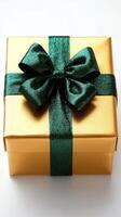 Gold gift box with green ribbon and bow photo