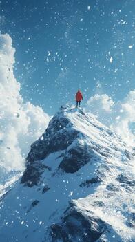 A man standing on top of a mountain in the snow photo