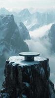 A table on top of a mountain with snow and clouds photo