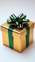Gold gift box with green ribbon and bow on white background photo
