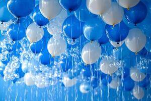 Blue and white balloons floating in the air photo