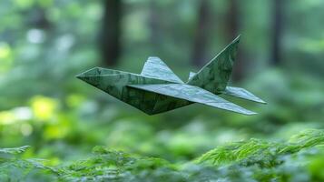 A green paper airplane flying through the forest photo