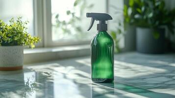 Green bottle of cleaning spray on a table with potted plants photo
