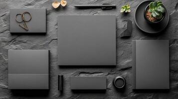 Stylish black stationery arrangement with accessories on a dark background photo