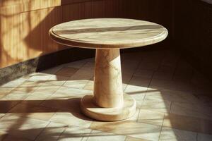 A marble table with a circular base and a shadow on the floor photo
