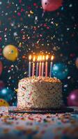 A birthday cake with five lit candles on top photo