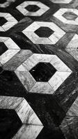 Black and white photo of a floor with hexagonal tiles
