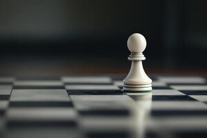 A white chess piece on a black and white checkered floor photo