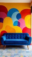 A colorful wall with a blue couch in front of it photo