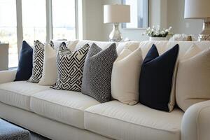 A white couch with black and white pillows photo