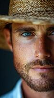 A man with blue eyes wearing a straw hat photo