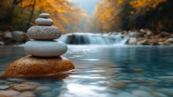 A stack of stones sitting on top of a rock in a river photo