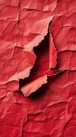 A red crumpled paper with a hole in it photo