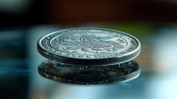 Clear glass disc resting on a reflective surface with water droplets around it photo