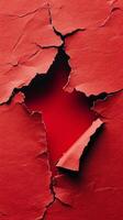 A hole in a red paper with a hole in it photo