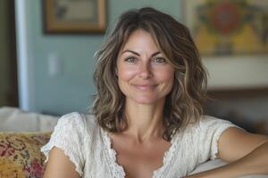 A woman sitting on a couch with her arms crossed photo