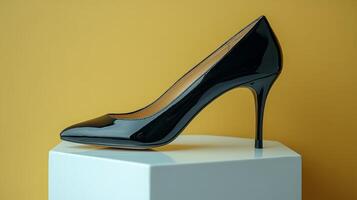 Black high heeled shoe on a pedestal photo