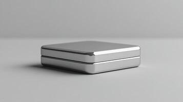 Silver metallic box on textured black surface with reflective finish and smooth edges photo