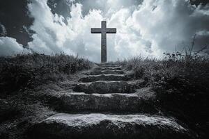A cross is standing on top of a hill with steps leading to it photo