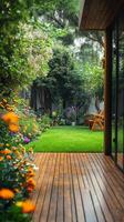 A wooden deck with flowers and a lawn photo