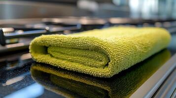 A green towel on a stove photo