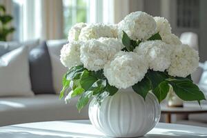 A white vase with white flowers sitting on a table photo