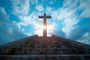 Sunlight shining through cross at top of stone steps under blue sky photo