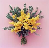 Vibrant bouquet of bright yellow flowers with green foliage on a pink background photo