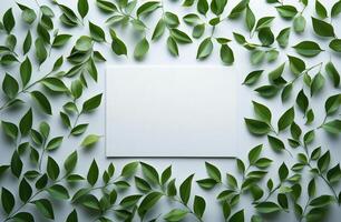 Green leaves surround a blank card on a light surface creating a fresh and natural vibe photo