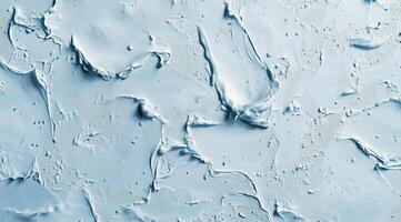 Textured blue surface with abstract patterns created by layered material during artistic application photo