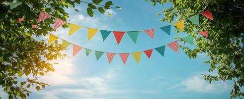 Colorful bunting flags decorate a sunny sky during a festive celebration photo