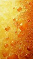 Bubbles rising in a vibrant orange and yellow liquid against a textured background photo