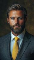 Smartly dressed man with beard and blue eyes poses confidently in a studio setting photo