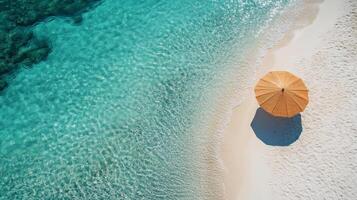 Relaxing beach view with a blue umbrella and clear turquoise waters on a sunny day photo