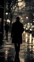 A man walking down a street in the rain photo