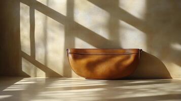 A tan leather purse sitting on a table photo