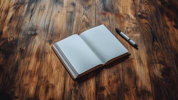 An open notebook and pen on a wooden table photo
