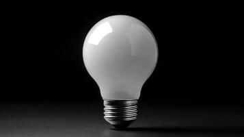 A white light bulb is shown on a black background photo