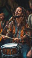 A man with dreadlocks playing drums photo