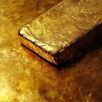 A lustrous gold bar gleams against its textured golden backdrop photo
