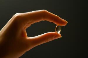 A person holding a small piece of gold in their hand photo
