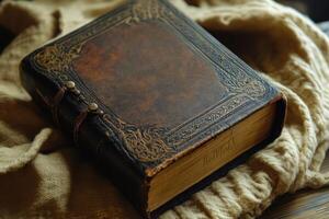 An intricately decorated antique leather bound book is displayed photo