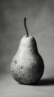 A black and white photo of a pear