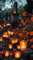 Orange flowers and candles in a cemetery photo
