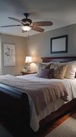 A bedroom with a large bed and a ceiling fan photo