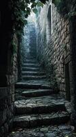 Stone steps ascend a narrow passage flanked by ancient walls photo