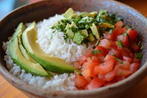 A bowl of rice, avocado, tomatoes and rice photo