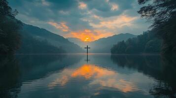 A cross is on a lake in front of a mountain photo