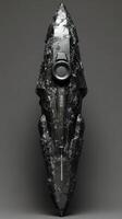Futuristic obsidian device displaying intricate carvings and technological components photo